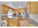 Spacious kitchen featuring light wood cabinets, granite countertops, and stainless steel appliances at 8160 W 81St Pl, Arvada, CO 80005