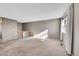 Bright living room featuring neutral carpeting and a large window at 8160 W 81St Pl, Arvada, CO 80005