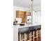 Modern kitchen with wood cabinets, white tile, and a large island at 3328 Osage St, Denver, CO 80211