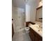 Bathroom with shower/tub combo and wood vanity at 3658 S Norfolk Way, Aurora, CO 80013