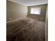 Simple bedroom with brown carpet and window at 3658 S Norfolk Way, Aurora, CO 80013