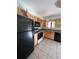 Bright kitchen features wood cabinets, tile flooring, and a full suite of appliances at 3658 S Norfolk Way, Aurora, CO 80013