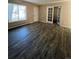 Spacious living room featuring wood-look floors and french doors at 3658 S Norfolk Way, Aurora, CO 80013