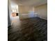 Living room with wood-look floors and view into kitchen at 3658 S Norfolk Way, Aurora, CO 80013
