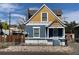 Charming two-story home with a yellow and blue exterior at 523 W 8Th Ave, Denver, CO 80204
