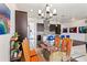 Open dining area with glass top table and orange chairs near kitchen at 6210 Dakota Ridge Dr, Littleton, CO 80125