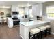 Modern kitchen with white cabinets, quartz counters, and stainless steel appliances at 4185 S Logan St, Englewood, CO 80113