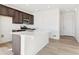 Modern kitchen with an island and dark brown cabinets at 4550 Boone Cir, Brighton, CO 80601