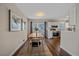 Bright dining room with kitchen and hardwood floors at 6896 Newcombe St, Arvada, CO 80004