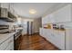 Modern kitchen with stainless steel appliances and white cabinetry at 6896 Newcombe St, Arvada, CO 80004