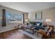 Bright living room with hardwood floors and large window at 6896 Newcombe St, Arvada, CO 80004