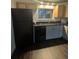 Modern kitchen with black appliances and wood cabinets at 2710 W 86Th Ave # 49, Westminster, CO 80031