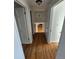 View down a hallway with hardwood floors and doors to bedrooms at 3006 S Fenton St, Denver, CO 80227