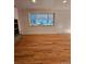 Living room with hardwood floors and large window at 3006 S Fenton St, Denver, CO 80227