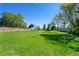 Spacious grassy backyard with a wooden fence at 580 S Parfet St, Lakewood, CO 80226