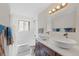Updated bathroom with double vanity and modern fixtures at 580 S Parfet St, Lakewood, CO 80226