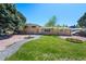 Ranch-style home with a well-manicured lawn and mature trees at 580 S Parfet St, Lakewood, CO 80226