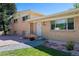 Brick ranch home with a covered entryway and landscaped yard at 580 S Parfet St, Lakewood, CO 80226