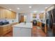 Bright kitchen with island, stainless steel appliances, and light wood cabinets at 580 S Parfet St, Lakewood, CO 80226