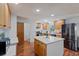 Spacious kitchen featuring an island, stainless steel appliances, and ample cabinetry at 580 S Parfet St, Lakewood, CO 80226
