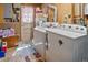 Basement laundry room with washer, dryer, and extra storage at 580 S Parfet St, Lakewood, CO 80226