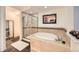 Spa-like bathroom with soaking tub, shower, and updated fixtures at 1705 Gaylord St # 107, Denver, CO 80206