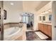 Bathroom with a large soaking tub and double vanity at 1705 Gaylord St # 107, Denver, CO 80206
