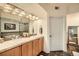 Double vanity bathroom with light wood cabinets and tile flooring at 1705 Gaylord St # 107, Denver, CO 80206