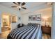 Bedroom with hardwood floors, ceiling fan, and ensuite bathroom access at 1705 Gaylord St # 107, Denver, CO 80206