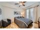 Spacious bedroom with hardwood floors, ceiling fan, and access to balcony at 1705 Gaylord St # 107, Denver, CO 80206