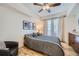 Bright bedroom with hardwood floors, ceiling fan, and striped bedding at 1705 Gaylord St # 107, Denver, CO 80206
