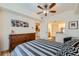 Spacious bedroom with hardwood floors, ceiling fan, and ensuite bathroom at 1705 Gaylord St # 107, Denver, CO 80206