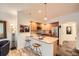 Modern kitchen with light wood cabinets and an island with seating at 1705 Gaylord St # 107, Denver, CO 80206