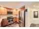 Modern kitchen with stainless steel appliances and light wood cabinets at 1705 Gaylord St # 107, Denver, CO 80206