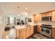 Modern kitchen with light wood cabinets and stainless steel appliances at 1705 Gaylord St # 107, Denver, CO 80206