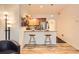 Eat-in kitchen with light wood cabinets, breakfast bar, and tile flooring at 1705 Gaylord St # 107, Denver, CO 80206