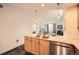 Modern kitchen features light wood cabinets, granite counters, and stainless steel appliances at 1705 Gaylord St # 107, Denver, CO 80206