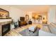 Living room with hardwood floors, fireplace, and kitchen view at 1705 Gaylord St # 107, Denver, CO 80206