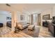 Open living room with hardwood floors and view into bedroom at 1705 Gaylord St # 107, Denver, CO 80206
