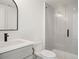 Modern bathroom with gray tile shower, white vanity, and black fixtures at 4660 W 9Th Ave, Denver, CO 80204