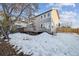 Spacious backyard with a large deck and snow covered ground at 3908 S Lisbon Way, Aurora, CO 80013