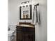 Bathroom with granite vanity, dark cabinets, and a mirror at 3908 S Lisbon Way, Aurora, CO 80013