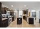 Modern kitchen with dark cabinets, granite counters, and stainless steel appliances at 3908 S Lisbon Way, Aurora, CO 80013