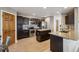 Modern kitchen with dark cabinets, granite counters, and stainless steel appliances at 3908 S Lisbon Way, Aurora, CO 80013