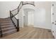 Bright and spacious entryway with a curved staircase and hardwood floors at 5102 Hickory Oaks St, Castle Rock, CO 80104