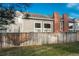 Fenced backyard of a two-story home with a brick chimney and siding at 12520 E Cornell Cir, Aurora, CO 80014