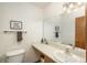 Clean and well-lit bathroom with a sink, toilet, and large mirror at 12520 E Cornell Cir, Aurora, CO 80014