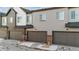 Rear view of townhomes with attached garages at 446 Millwall Cir, Castle Pines, CO 80108