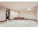 Unfinished basement with a tiled alcove and carpet at 26600 Mowbray Ct, Evergreen, CO 80439