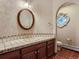 Charming bathroom with tiled counter, decorative sink and stained glass window at 26600 Mowbray Ct, Evergreen, CO 80439